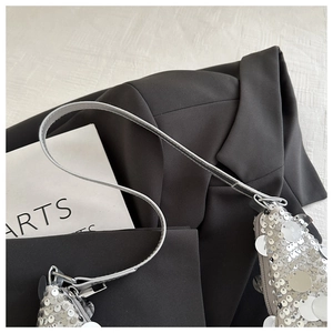 Detail of silver sequin shoulder bag featuring high-density sequins and metallic hook