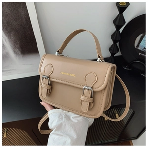Detail showing the beige PU leather flap with decorative buckles and top handle