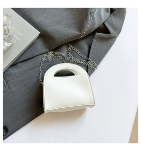 Detailed view of a white PU leather semi-circle handbag with a silver metal chain strap