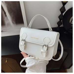 Detailed close-up of white retro crossbody bag with gold Fashion & Bag lettering and strap