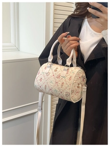 White pleated Boston barrel bag featuring pastel cartoon prints and adjustable strap
