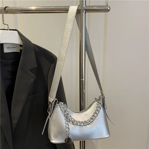 Silver metallic crescent underarm bag with decorative metal chain and sleek shoulder strap