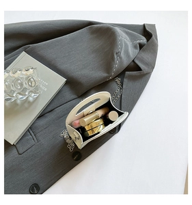 Interior view showing the capacity of a minimalist white handbag with silver chain strap