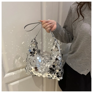 Detail shot of a silver sequin hobo bag showing metallic shine and handle texture