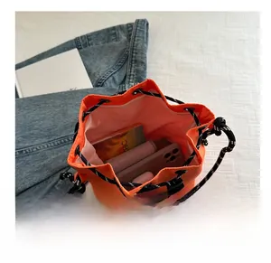 Top view of orange nylon bucket bag showing large capacity for phone and accessories