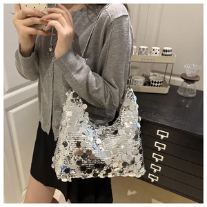 Detail of silver sequin hobo bag showing large metallic discs with mirror reflections