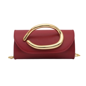 Chic red leather crossbody bag with a distinctive large gold handle and chain strap