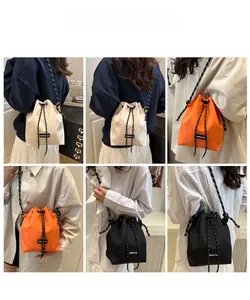 Detail view of nylon drawstring bucket bag with contrast straps and Creative Cat label