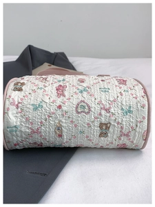 Detailed view of quilted cotton barrel bag with bear and rabbit prints and pink trim