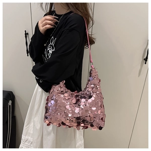 Detail of pink sequins on a designer shoulder bag with shiny metallic reflections