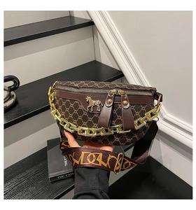 Detail of vintage brown chest bag with diamond pattern and gold horse logo plaque