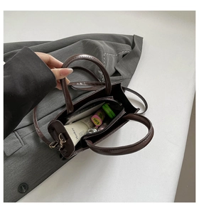 Interior view of deep brown leather crossbody bag showing large storage capacity