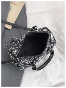 Detailed top view of the embroidered Boston bag interior with black lining and silver zipper
