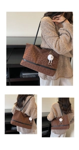 Detailed view of vintage leopard print tote bag featuring black straps and furry charm accessory