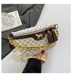 Detail of vintage beige pattern bag with gold horse logo and chunky chain strap