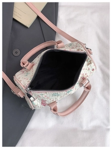 Top view of open floral barrel bag with bear prints, pink handles, and black interior lining