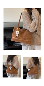 Detail of a leopard print tote bag with brown straps and a plush white charm accent