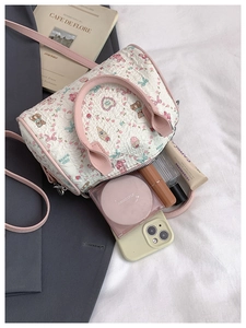 Detail of cute quilted handbag showing interior capacity for phone and cosmetics