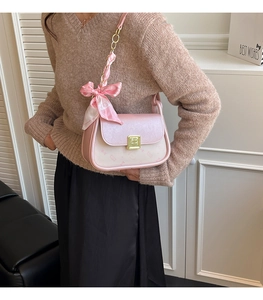 Pink square shoulder bag with silk scarf heart detail and gold metal buckle close-up
