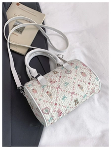 Detail of white Boston bag with cartoon prints and quilted texture for crossbody wear
