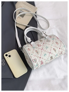 Detailed view of a white bubble texture Boston bag with cute cartoon animal prints