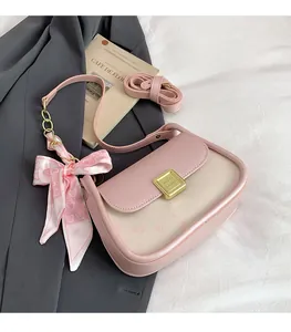 Close-up of pink and beige patchwork bag with a heart scarf and cat pattern print