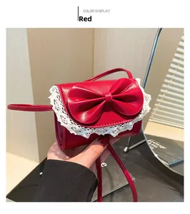 Detail of red square bag with matte PU leather, bow decoration and white lace edges