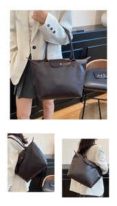 Detail view of large dark brown tote bag showing the dual zipper and snap button closure