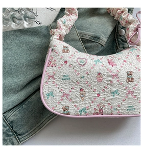 Detailed close-up of pink bow strap and 3D bubble texture on the bear printed bag