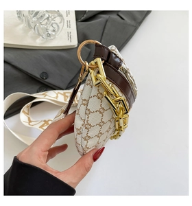 Close-up of retro logo print cross body bag with wide strap and gold chain detail
