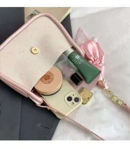 Flat lay of pink cat print crossbody bag showing interior space for cosmetics and phone
