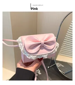 Detail of pink PU leather mini shoulder bag featuring a large bow and white lace trim