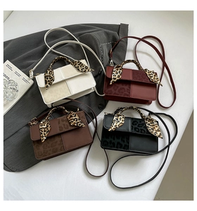 Flat lay of vintage style contrast color handbags in white, red, brown, and black options