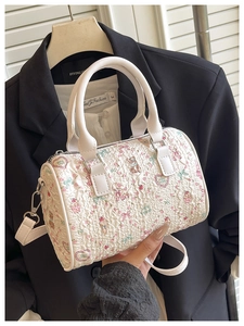 Detailed shot of white pleated mini barrel bag with cute colorful bear and heart patterns
