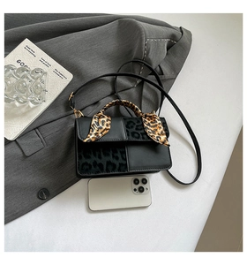 Mini handbag size comparison with a smartphone showing leopard print and scarf handle