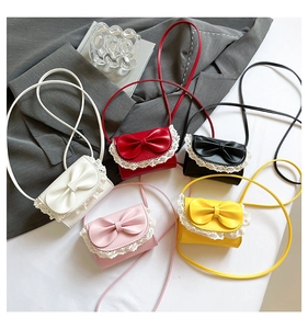 Close-up of five colorful mini crossbody bags with bow knots and lace trim details