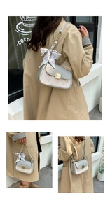 Detail of grey PU flap shoulder bag with cat print, gold buckle and silk scarf strap