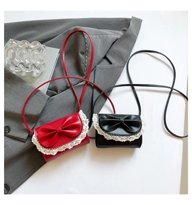 Red and black mini crossbody bags with large bows and white lace trim detail