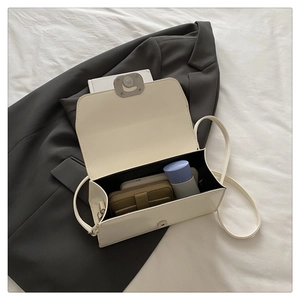 Interior view of white PU leather square handbag showing space for phone and makeup
