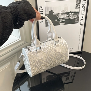White bucket bag with gold geometric embroidery and detachable leather shoulder strap