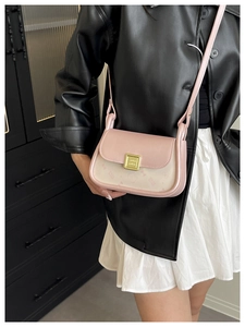 Detail shot of the pink cartoon crossbody bag with a golden square twist lock on the front