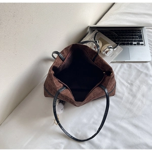 Detailed interior of leopard print tote bag with black lining and laptop essentials