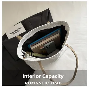 Top view of white woven tote bag interior showing ample storage for tablets and books