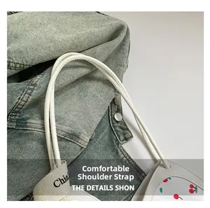 Close-up of a cherry-printed tote bag with a comfortable embroidered wide shoulder strap