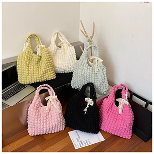Detailed display of bubble texture handbags with lace bows in six vibrant candy colors