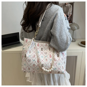 Quilted white tote bag detail with cute bear prints and elegant pearl chain strap
