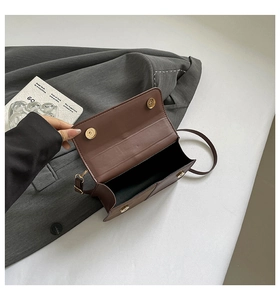 Top-down view of the brown leather shoulder bag interior with magnetic snap closure