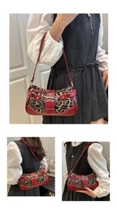 Detail view of leopard print shoulder bag with red leather trim and silver metal buckle