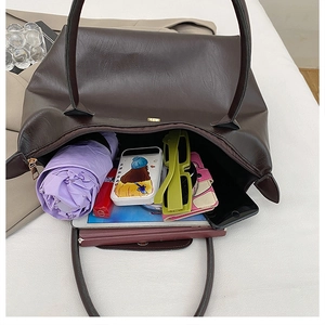 Interior view of large dark brown tote bag showing spacious capacity and pebbled texture