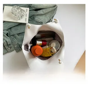 Detailed interior of the large white leather tote bag showing ample capacity for essentials